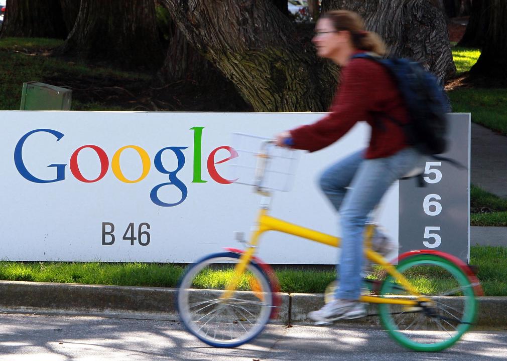A bicyclist rides by a sign at the Google headquarters in 2010