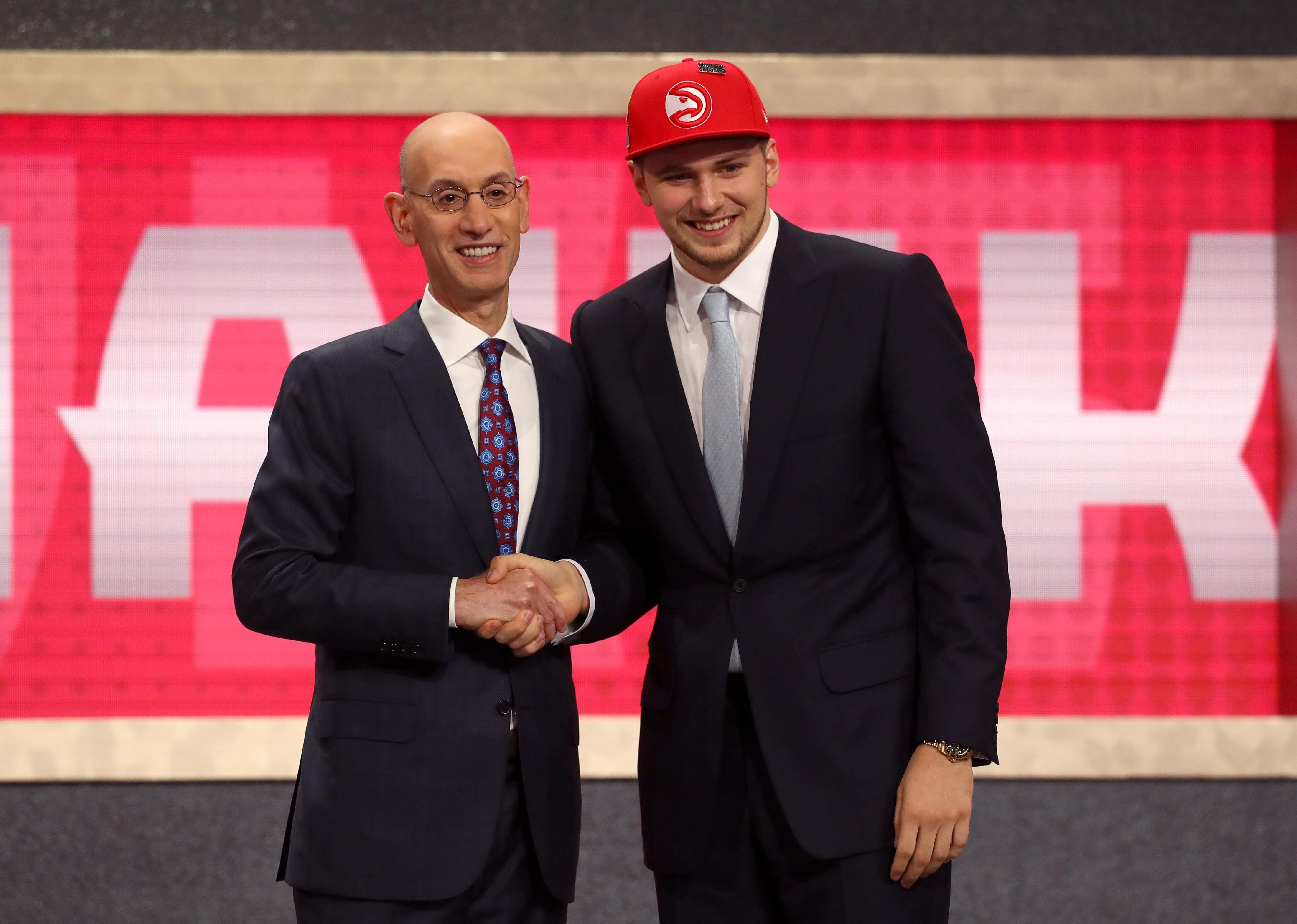 Luka Doncic with NBA Commissioner Adam Silver after being drafted.