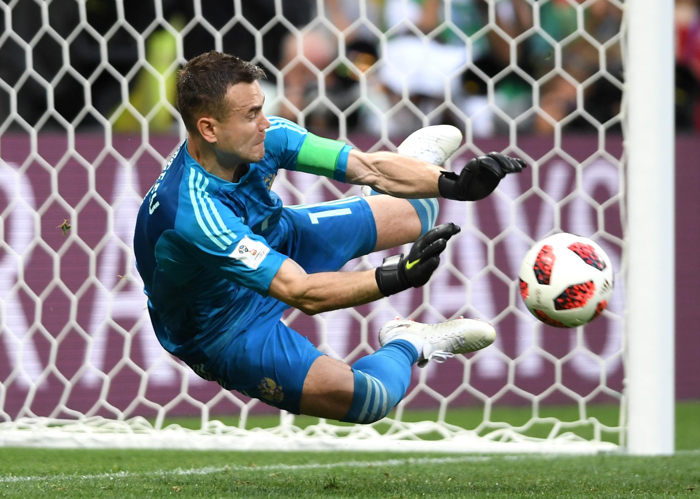 Igor Akinfeev of Russia saves the third penalty from Koke of Spain in the penalty shoot out during the 2018 FIFA World Cup
