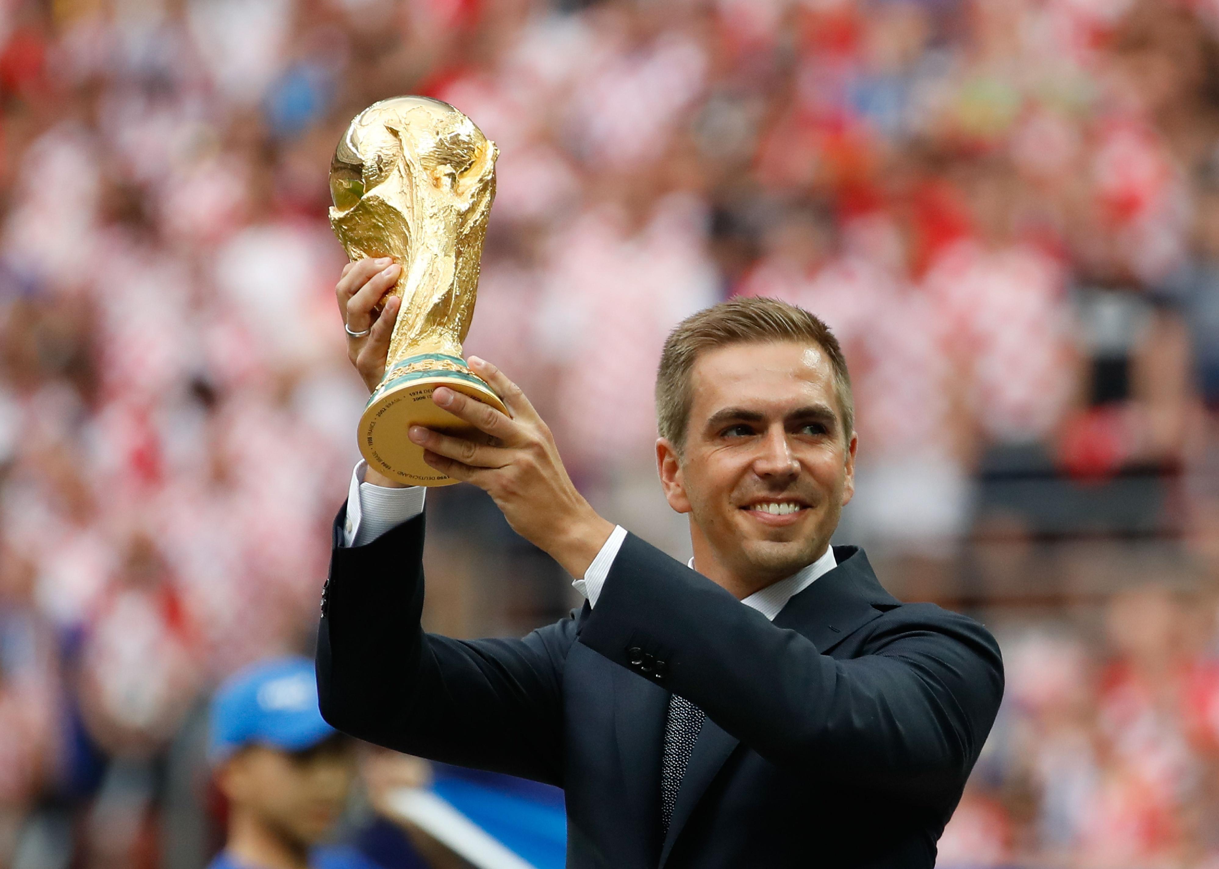 Philipp Lahm poses with the World Cup trophy