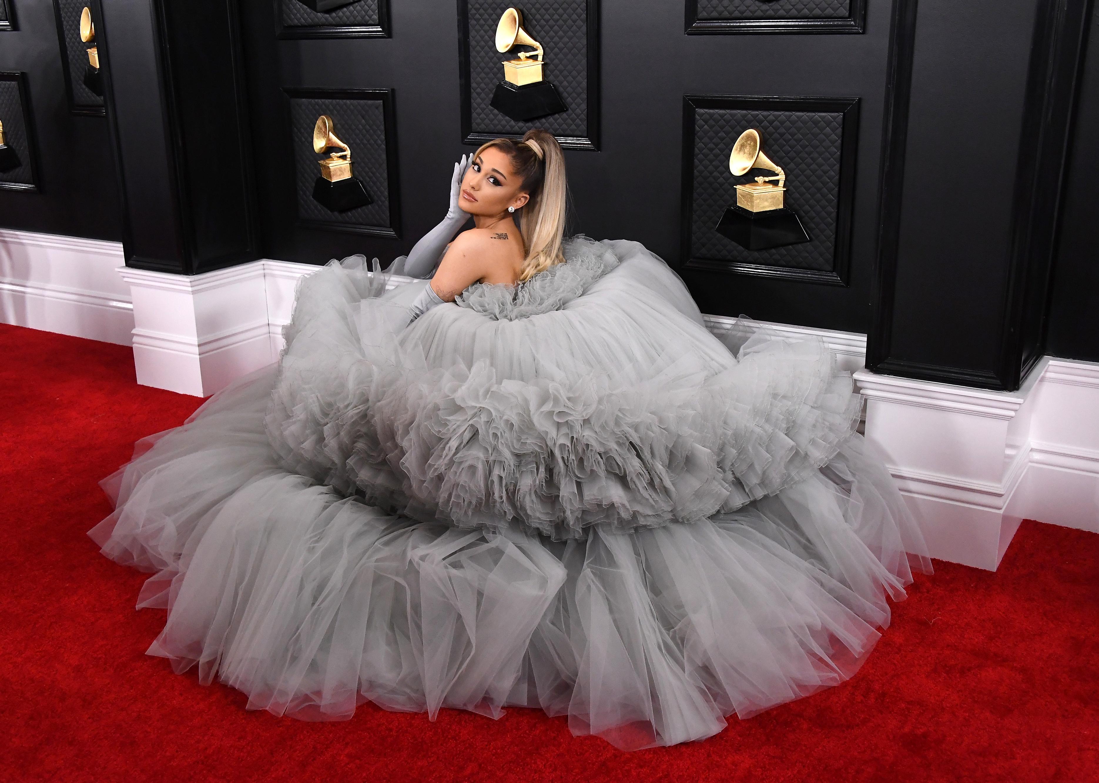 Ariana Grande posing in a grey tulle fluffy gown.
