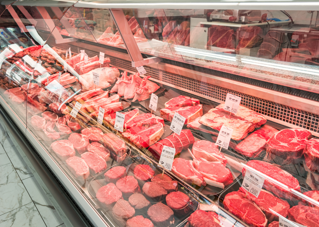 An array of steak meat in a display case at a supermarket.