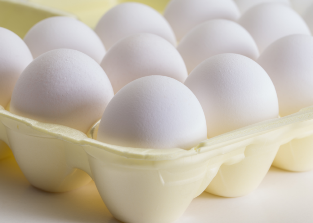 Closeup of white eggs in a carton.