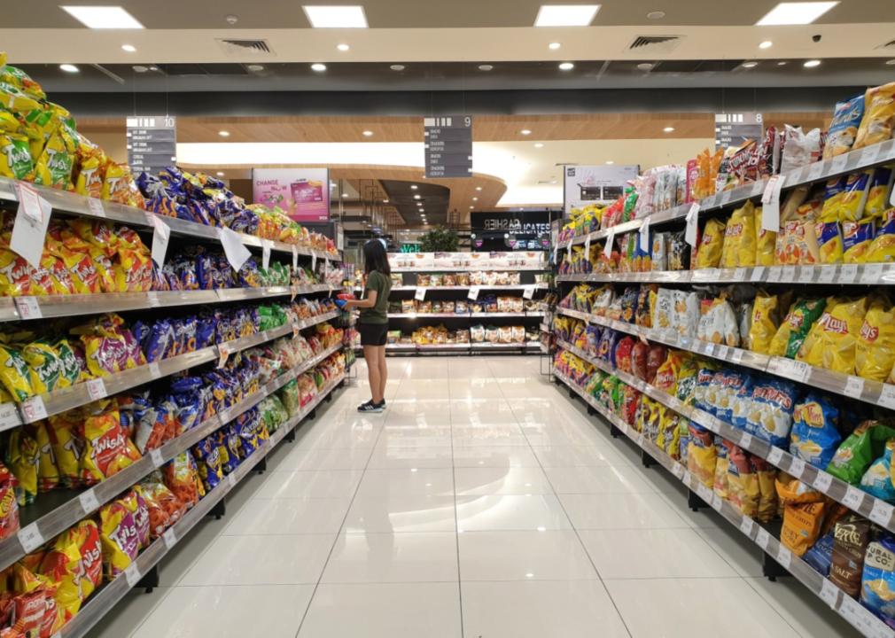 A full aisle of various chips at the grocery store.