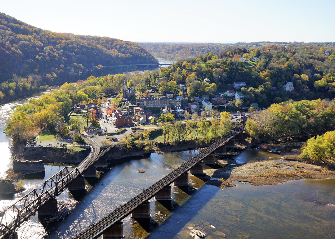 Aerial view of bridges going over water into Harpers Ferry.