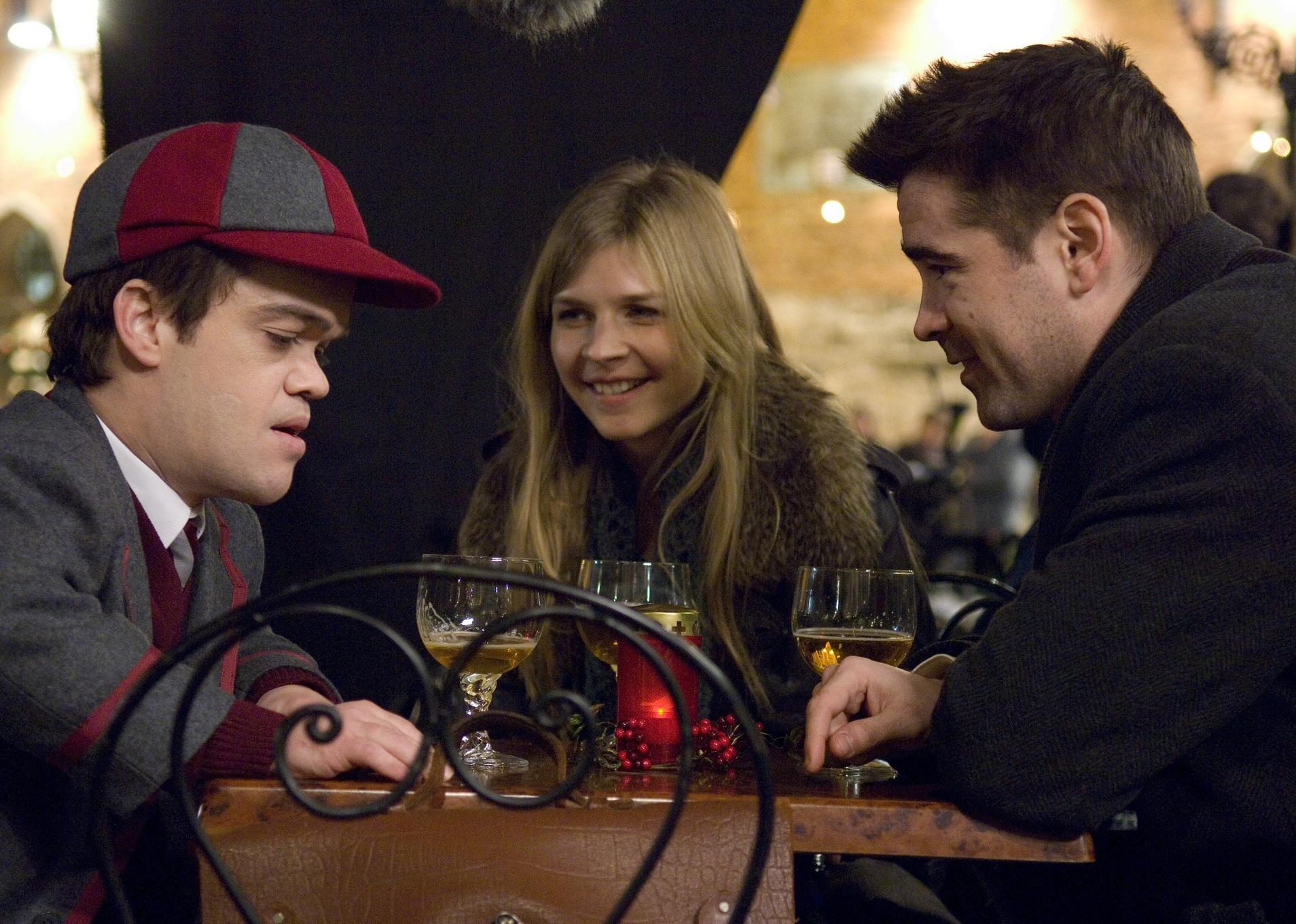 Colin Farrell having a beer with a man and woman.