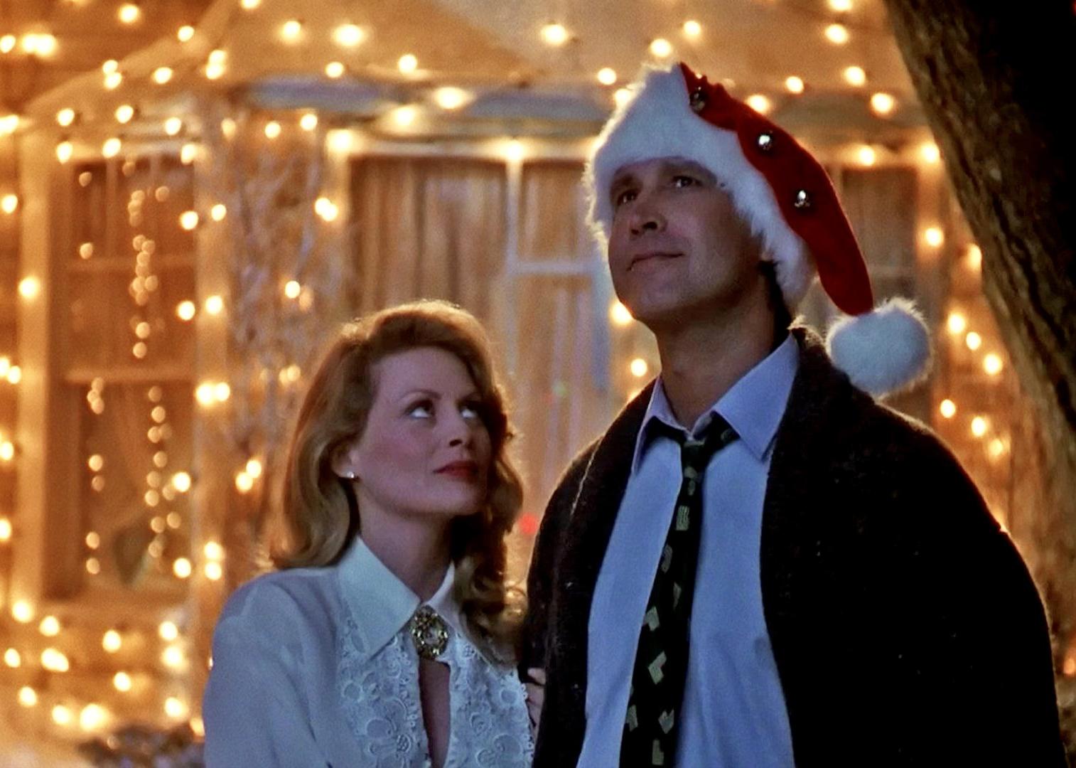 Beverly D'Angelo and Chevy Chase look up at the Christmas lights on their house.