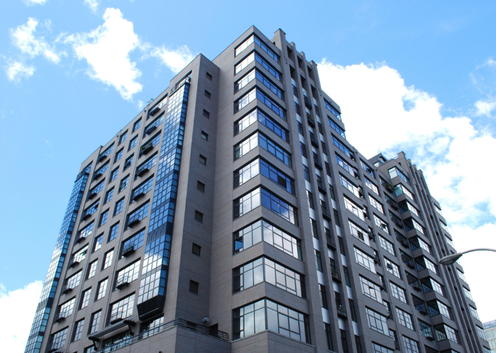 Tall modern condo against a blue sky.