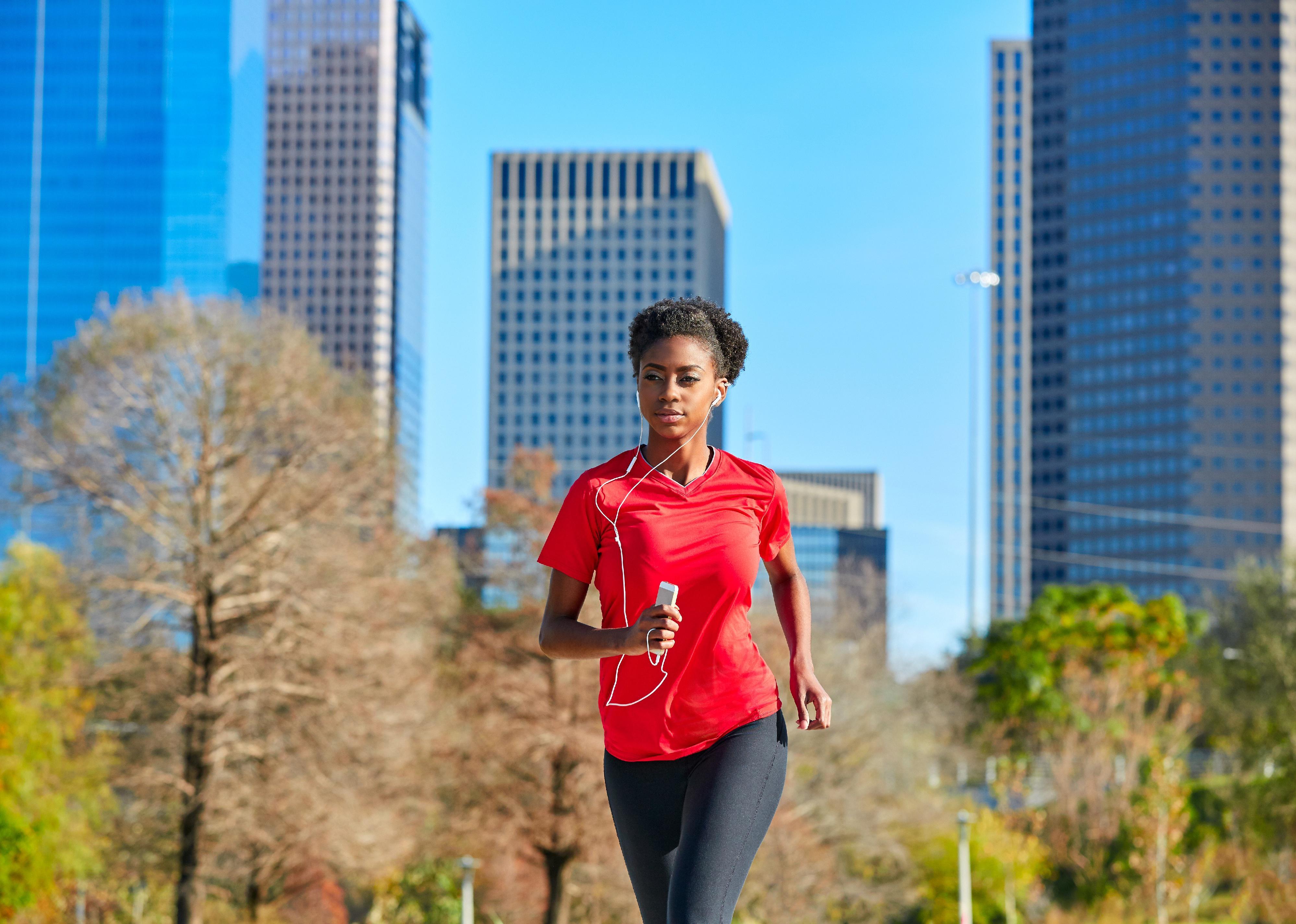 A woman jogging in a downtown area.