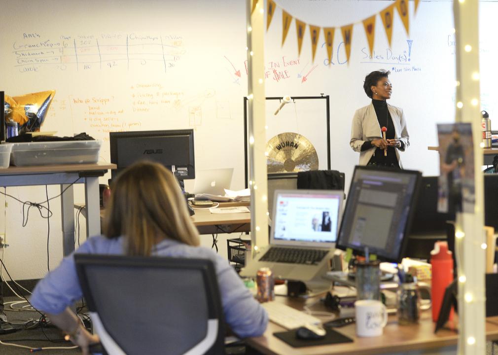 Promise Phelon, CEO of tech company TapInfluence, is pictured in the background of her office where they link marketers with bloggers and influencers.