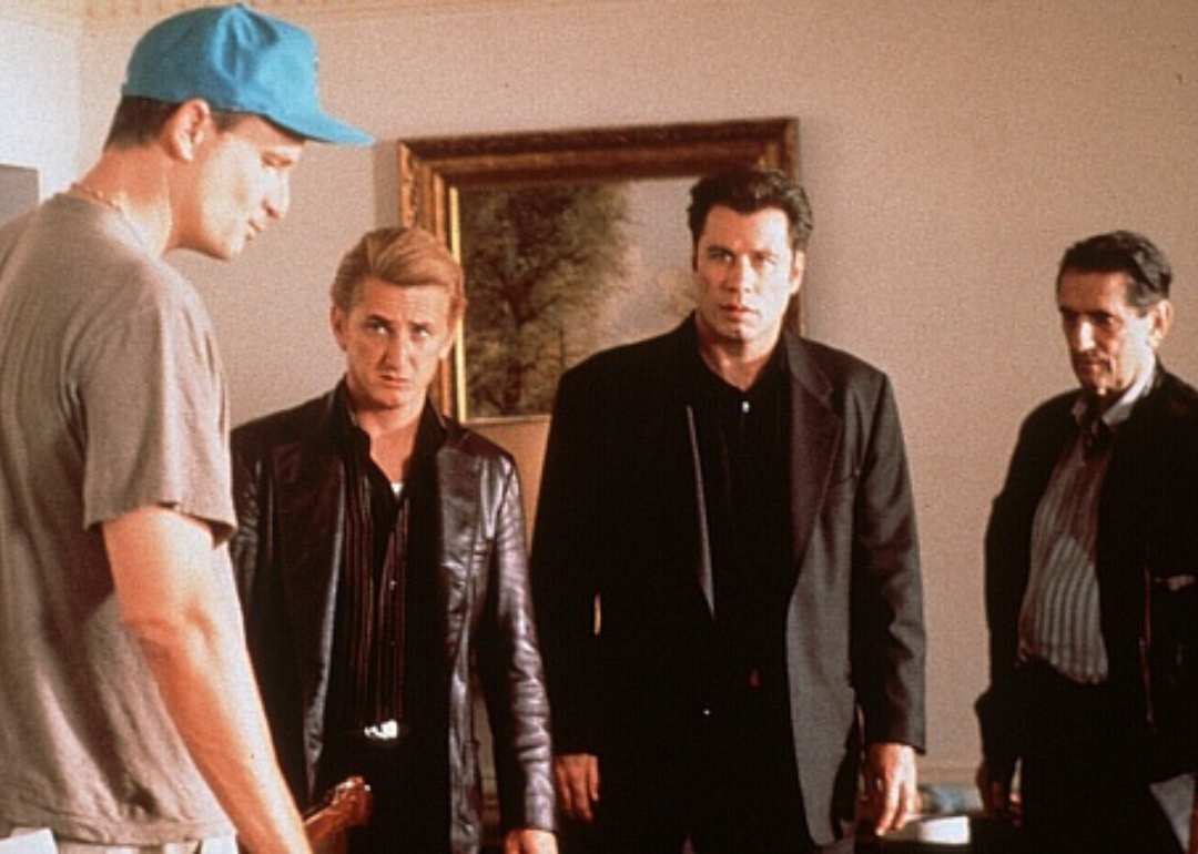John Travolta, Sean Penn, Nick Cassavetes, and Harry Dean Stanton stand together talking.