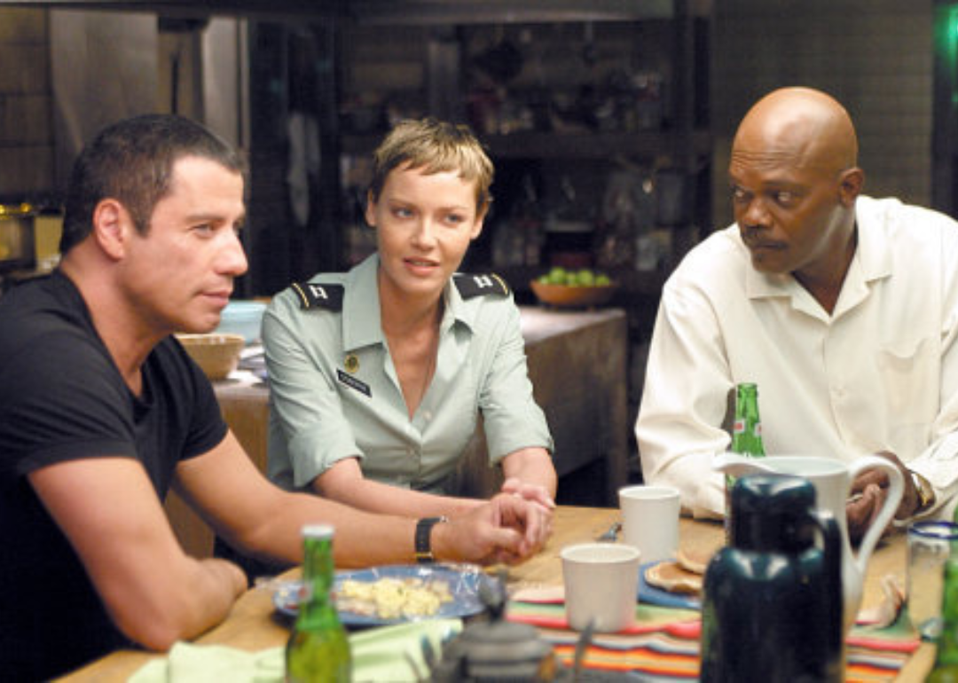 Samuel L. Jackson, John Travolta, and Connie Nielsen having beers and food at a table.