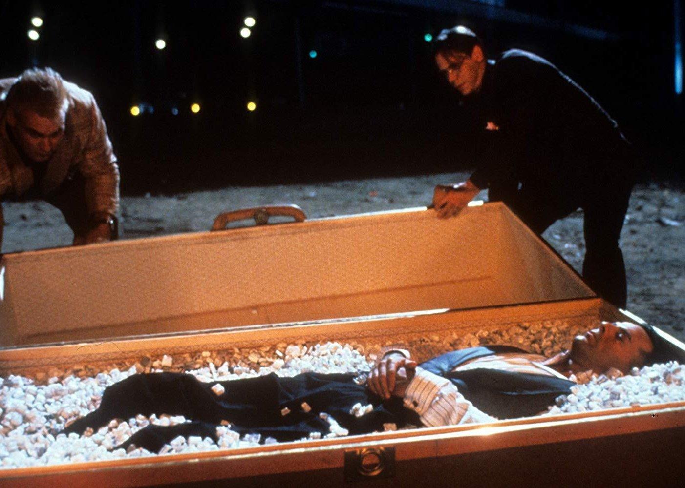Bruce Willis lying in a coffin