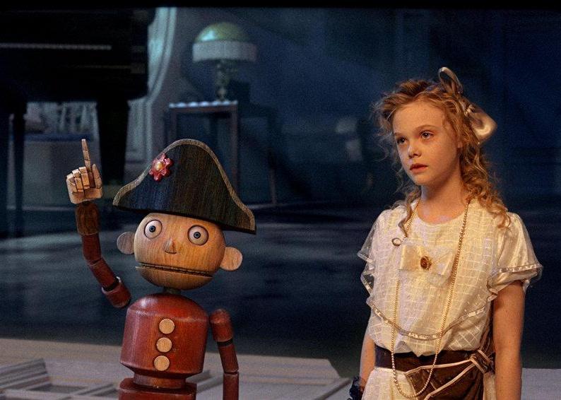 A toy soldier and a young girl look into the distance