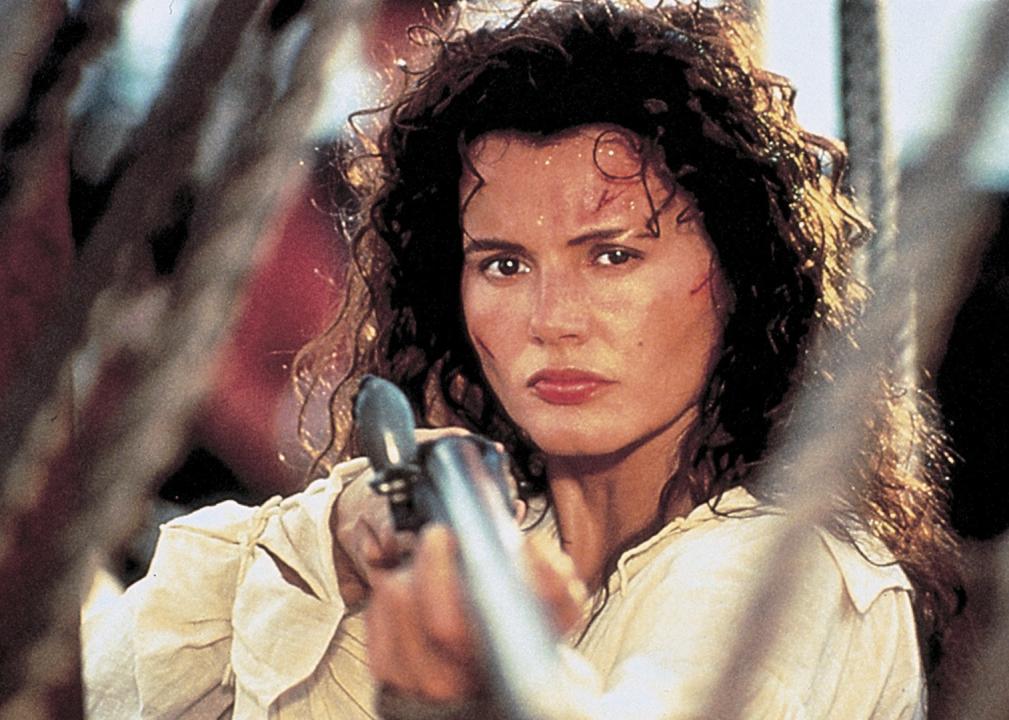 Geena Davis holds a rifle aboard a pirate ship.