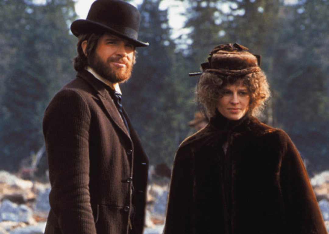 Warren Beatty in a brown suit and top hat and Julie Christie in a fur coat and hat with veil.