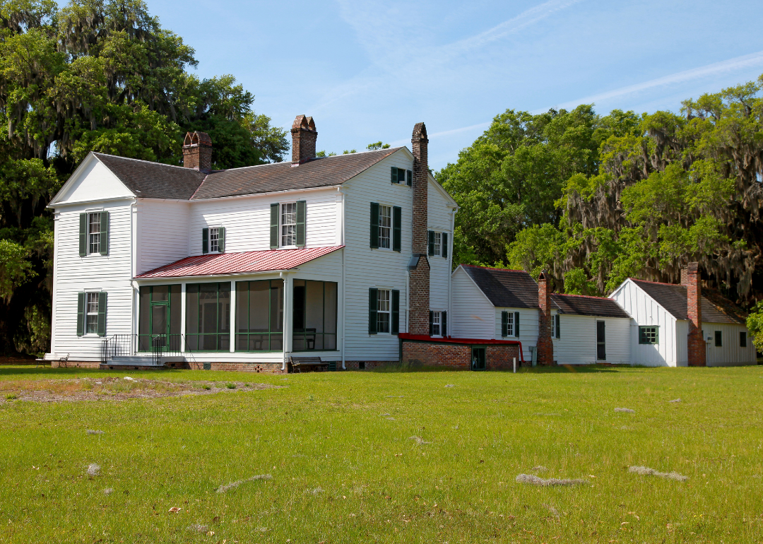 A white farm house in a rural setting.