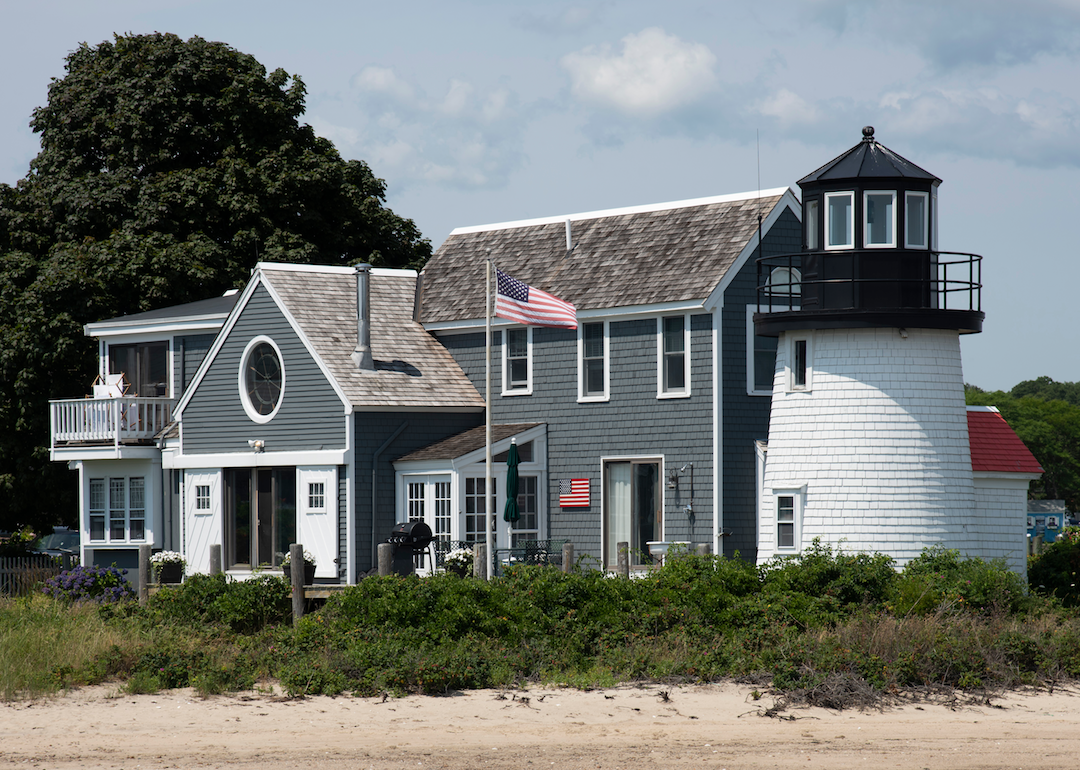 A traditional New England home with a small lighthouse attached.