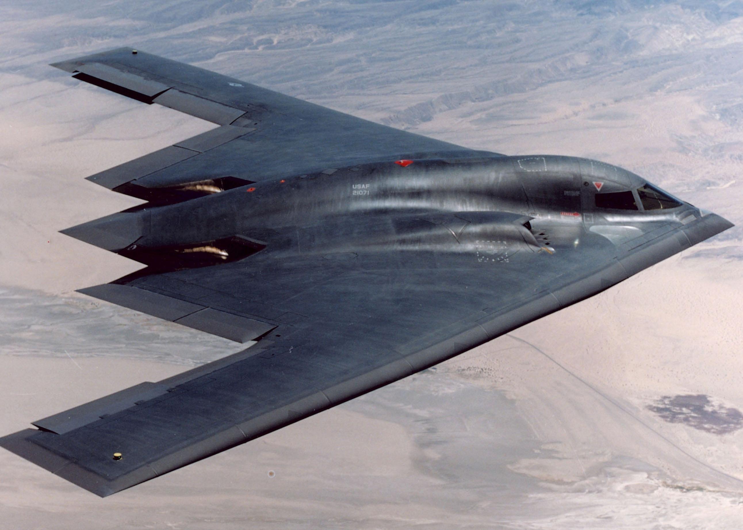 The B-2 Stealth Bomber flies over an Air Force base.