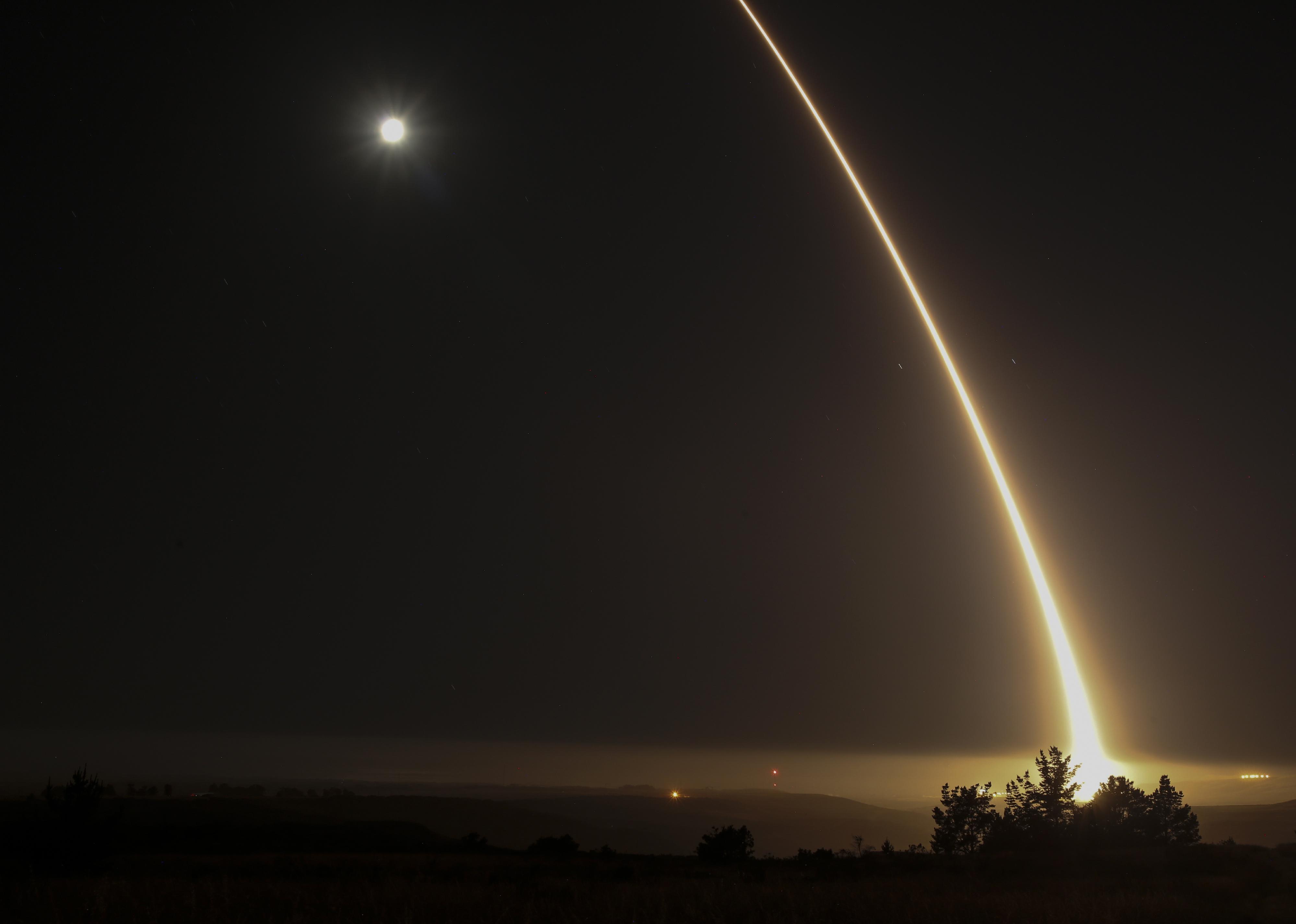 A streak of light in the night as a test missile goes across the sky.