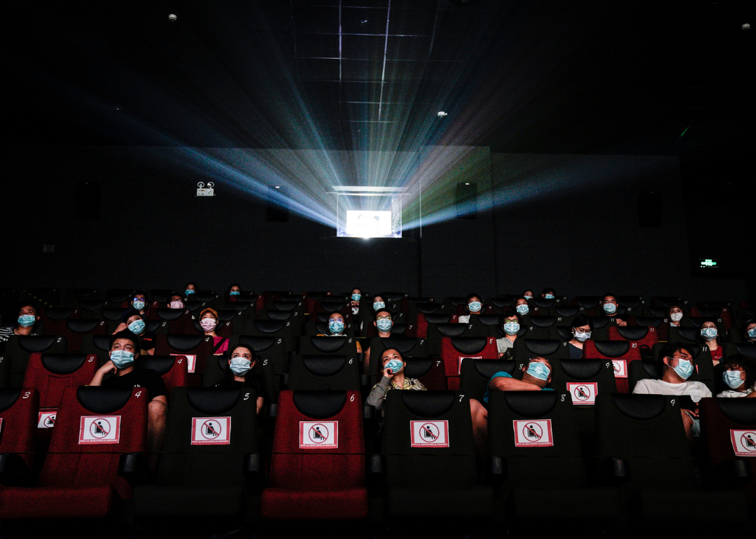 A movie theater with people wearing masks during COVID-19.