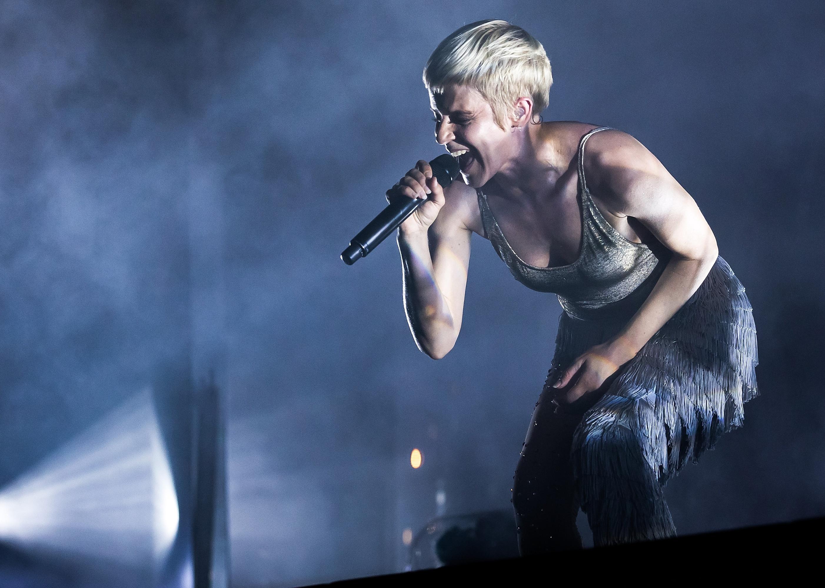 Robyn performing onstage.