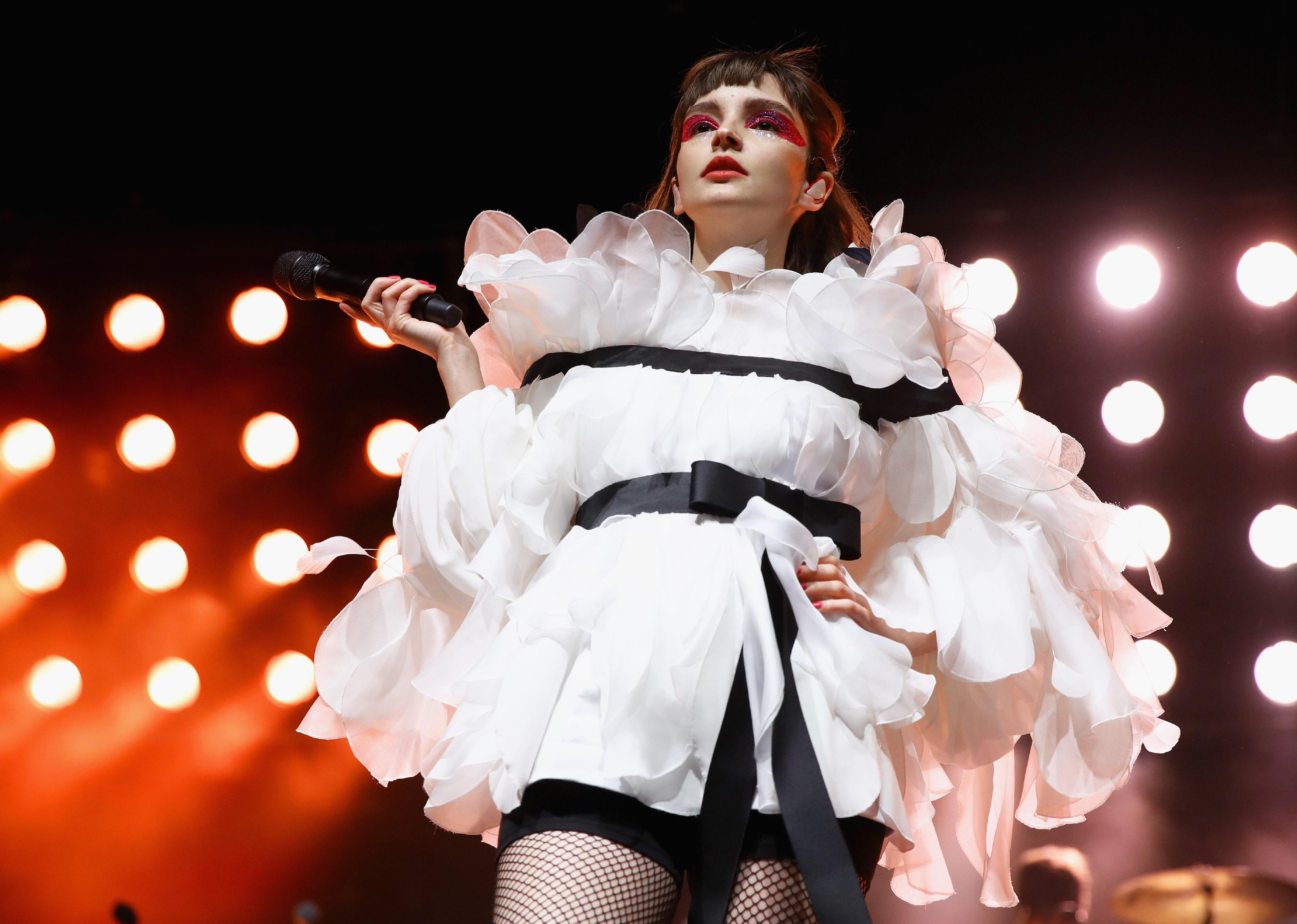 CHVRCHES performing onstage.