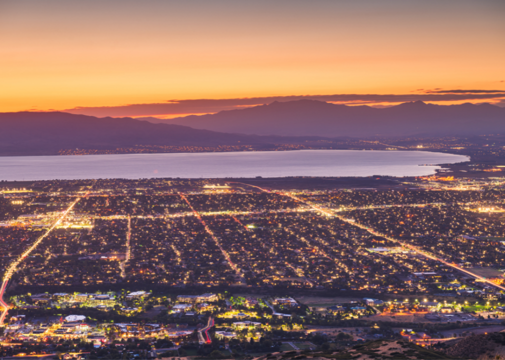 Provo, Utah aerial view with lit up downtown and orange sunset.