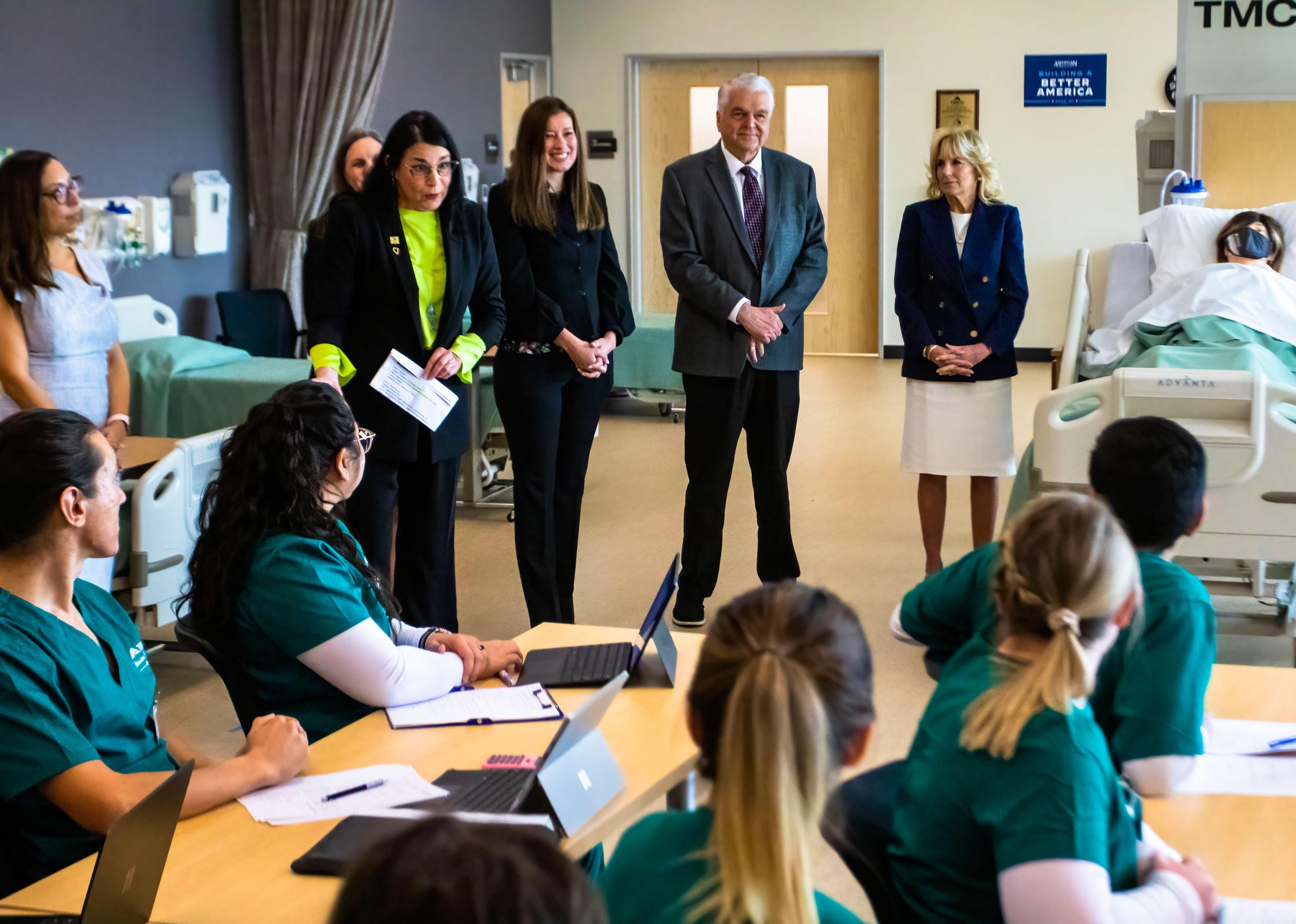 Governor Steve Sisolak (R) and Dr. Jill Biden (L) attending a nursing program classroom.