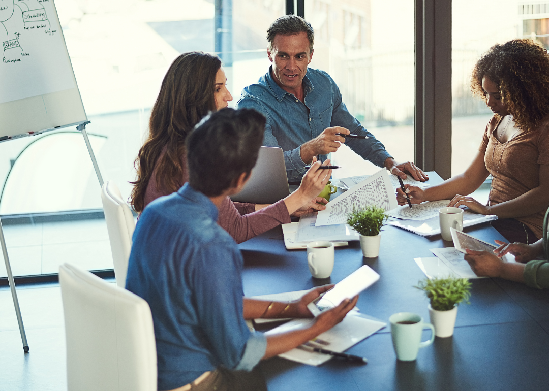 People sitting around a table at a work meeting.