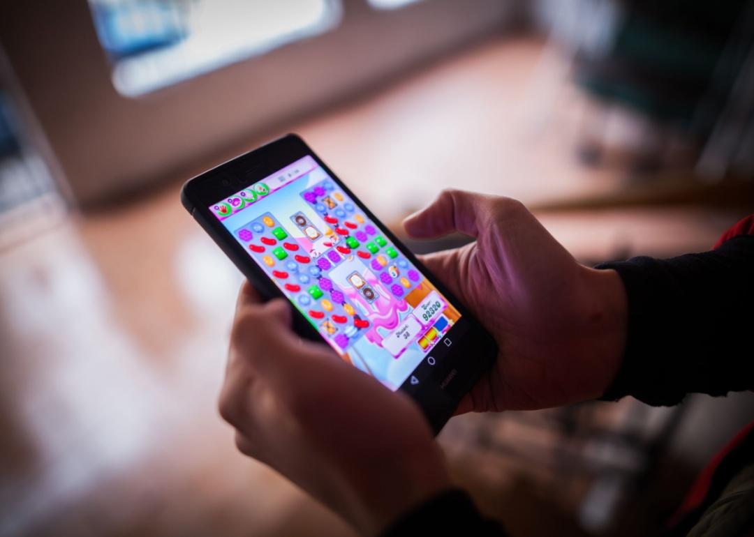 Playing candy crush game at a desk.