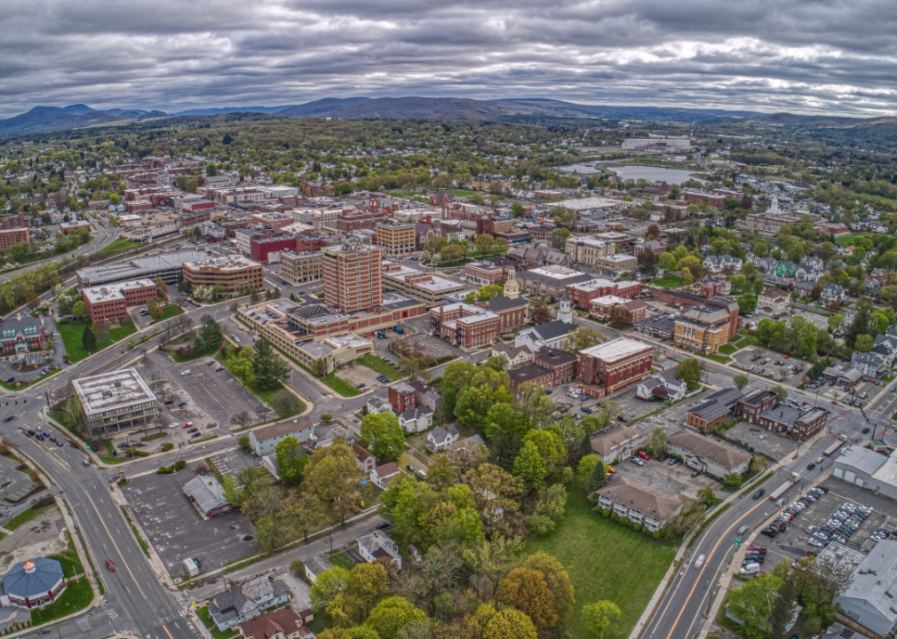 Aerial view of downtown Pittsfield, Massachusetts with mountains in the distance.