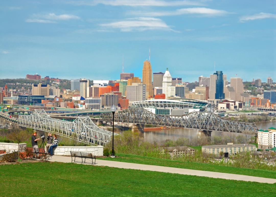 A view of downtown with a photographer taking pictures of two people in the foreground.