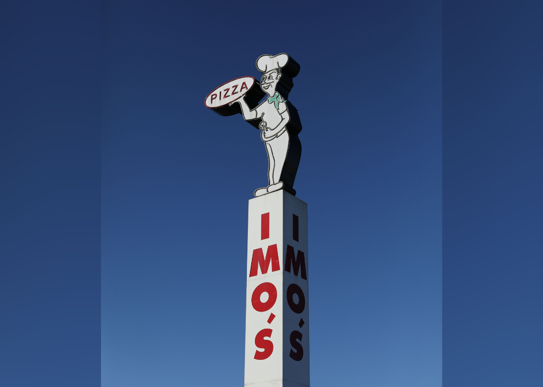 An Imo's Pizza sign with a chef holding a pizza crust.