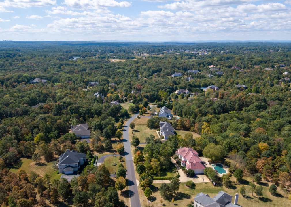 An aerial view of homes surrounded by trees.