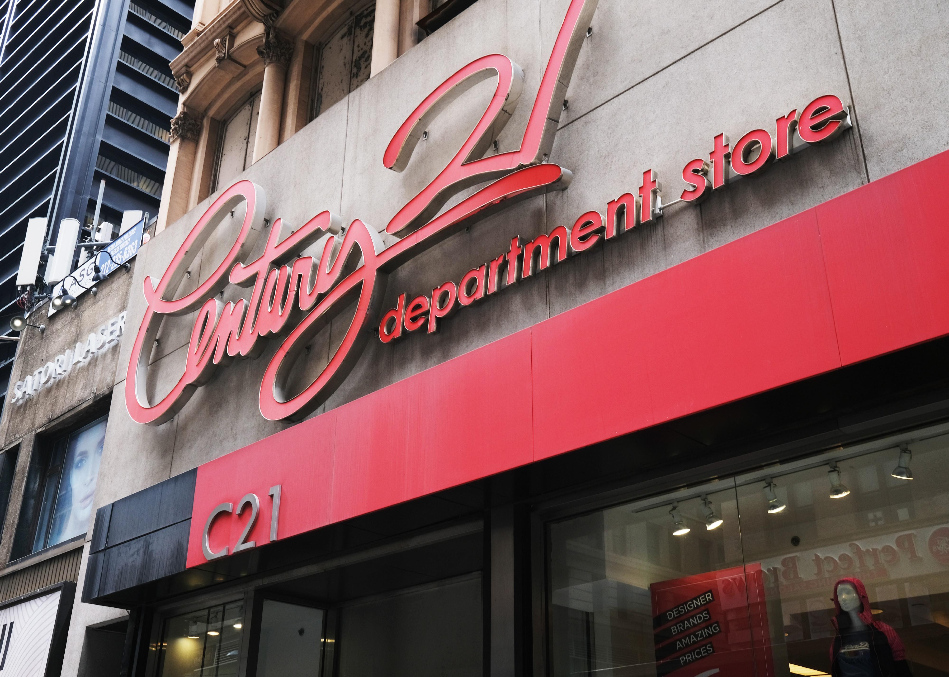 The exterior of a Century 21 department store with red signage.