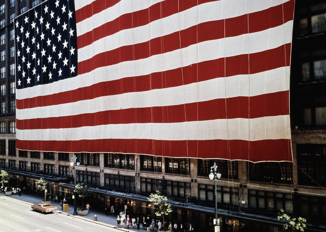 A giant American flag on the side of a building.