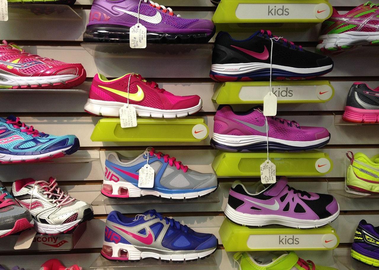 Athletic shoes on a display wall.