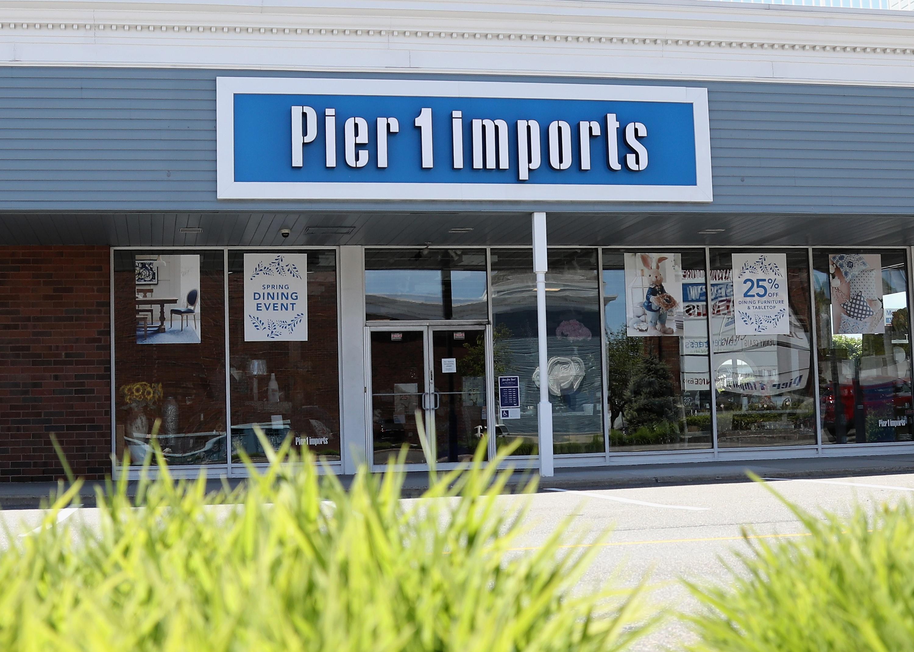 The exterior of a Pier 1 Imports store with a blue and white sign.