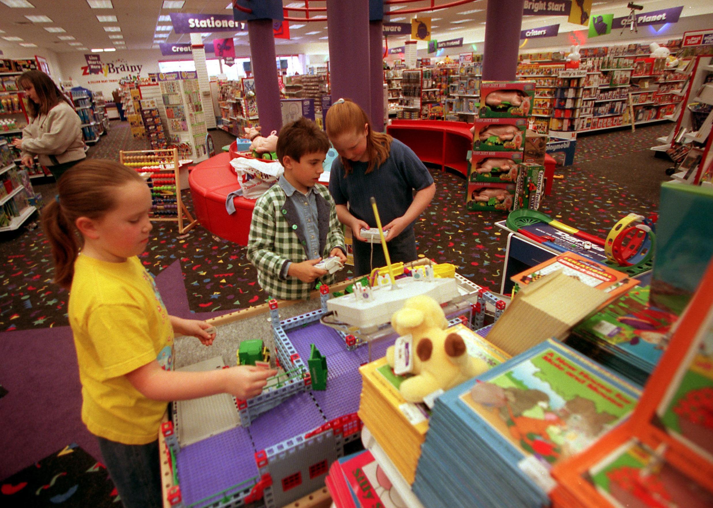 Kids playing at a toy store.