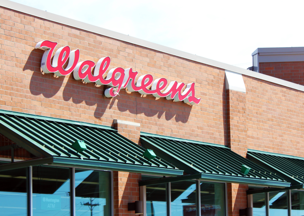 A brick Walgreens store with green awnings.