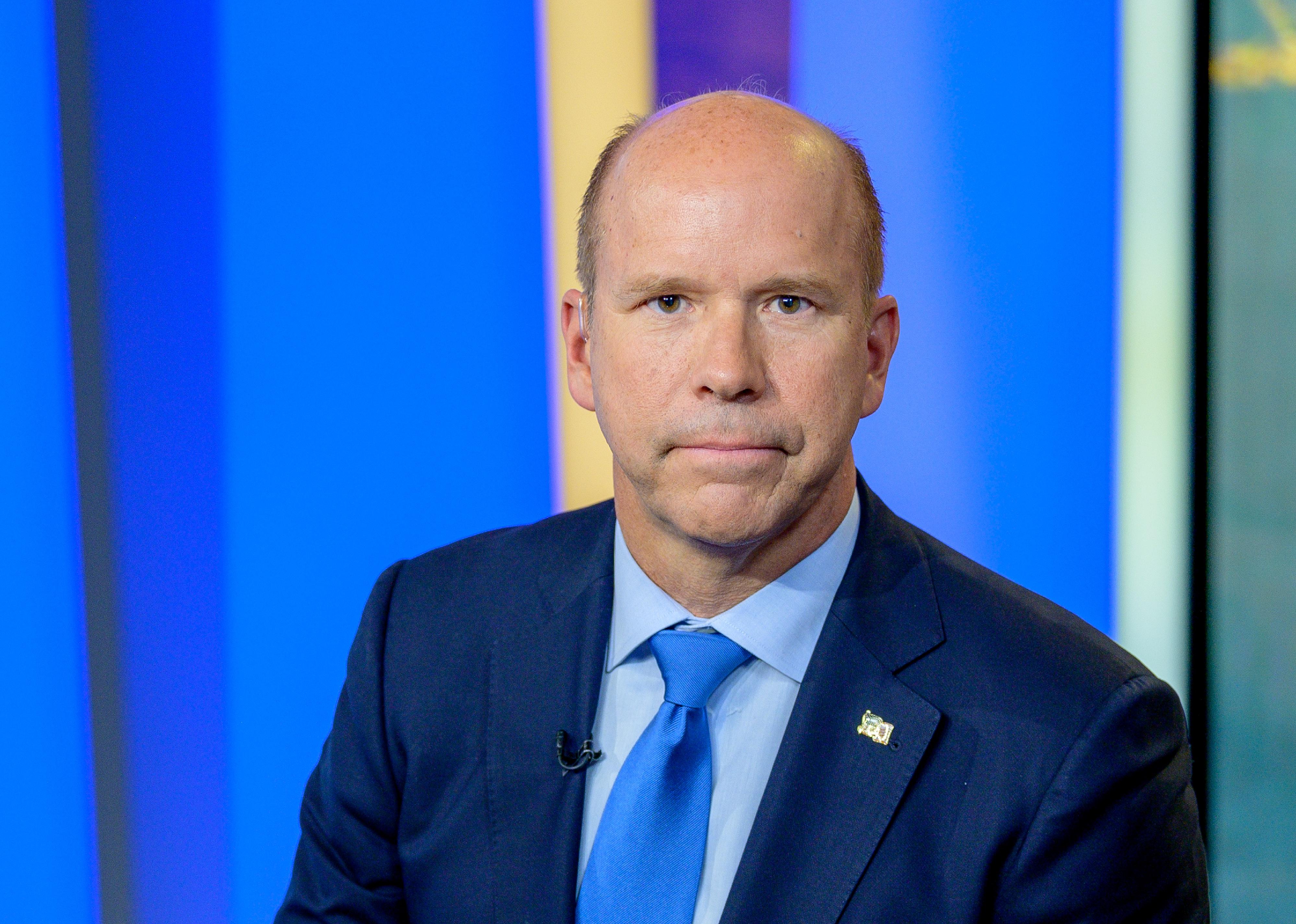 John Delaney in a suit at a news studio.