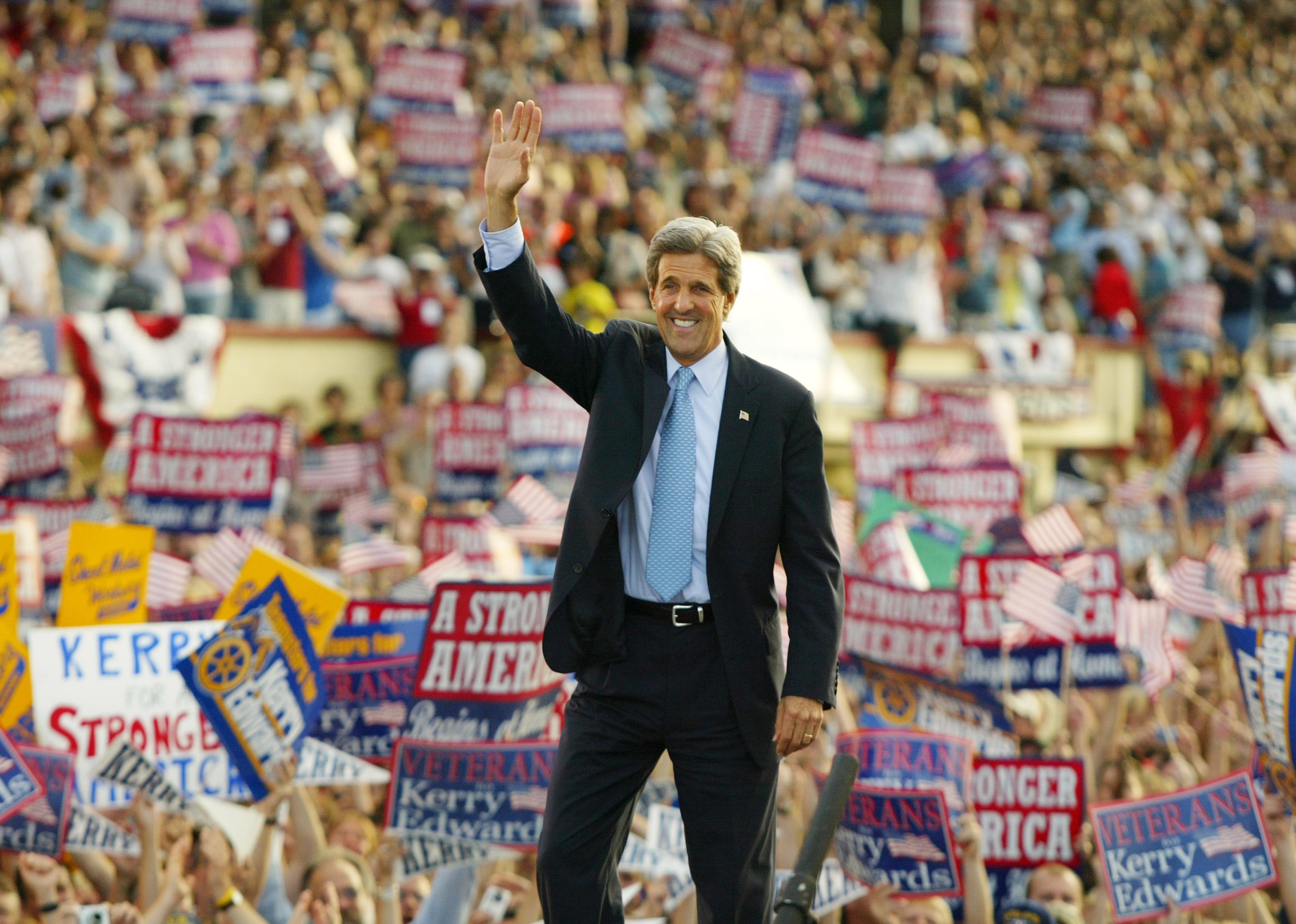 John Kerry waving during a campaign rally.