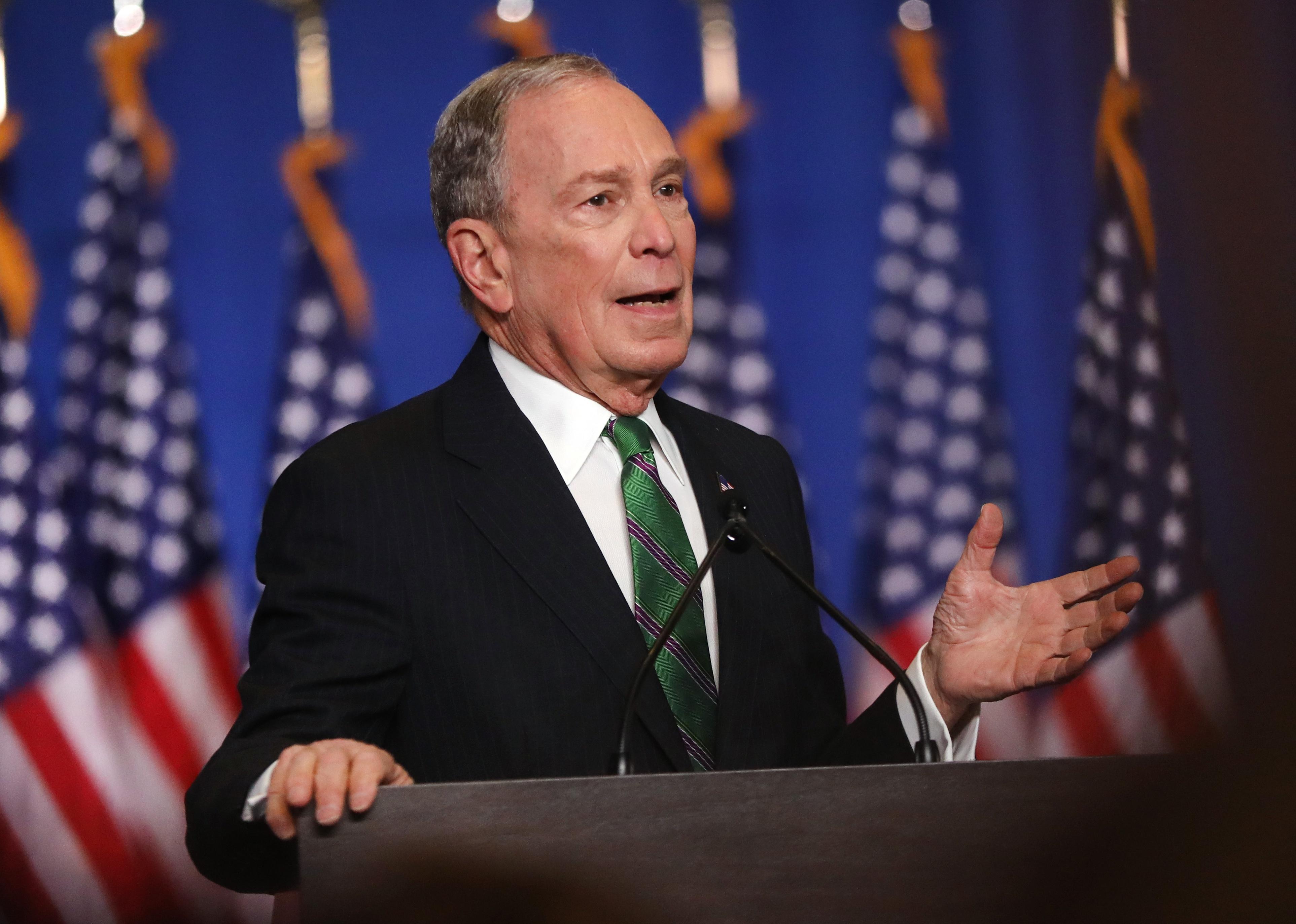 Michael Bloomberg giving a speech onstage.