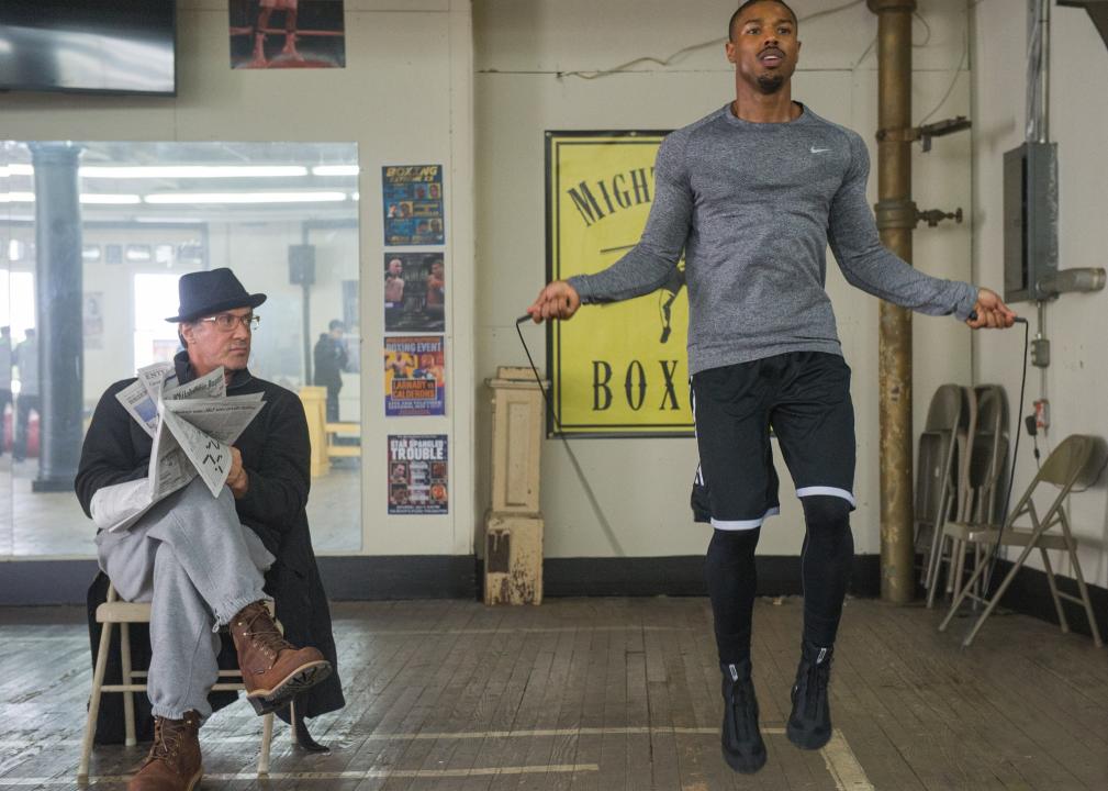 Sylvester Stallone reads the newspaper and watches Michael B. Jordan jump rope.