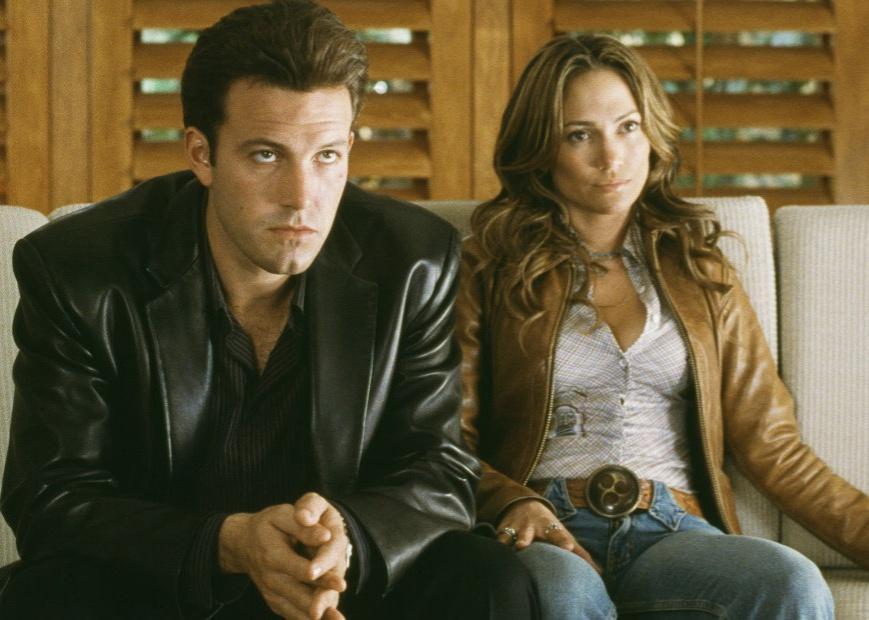 Ben Affleck and Jennifer Lopez sitting on a couch.