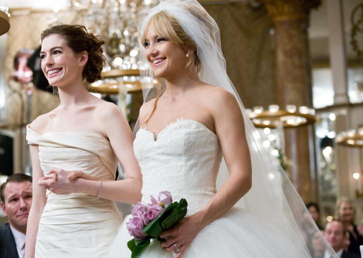 Kate Hudson in a wedding dress and Anne Hathaway in a white gown.