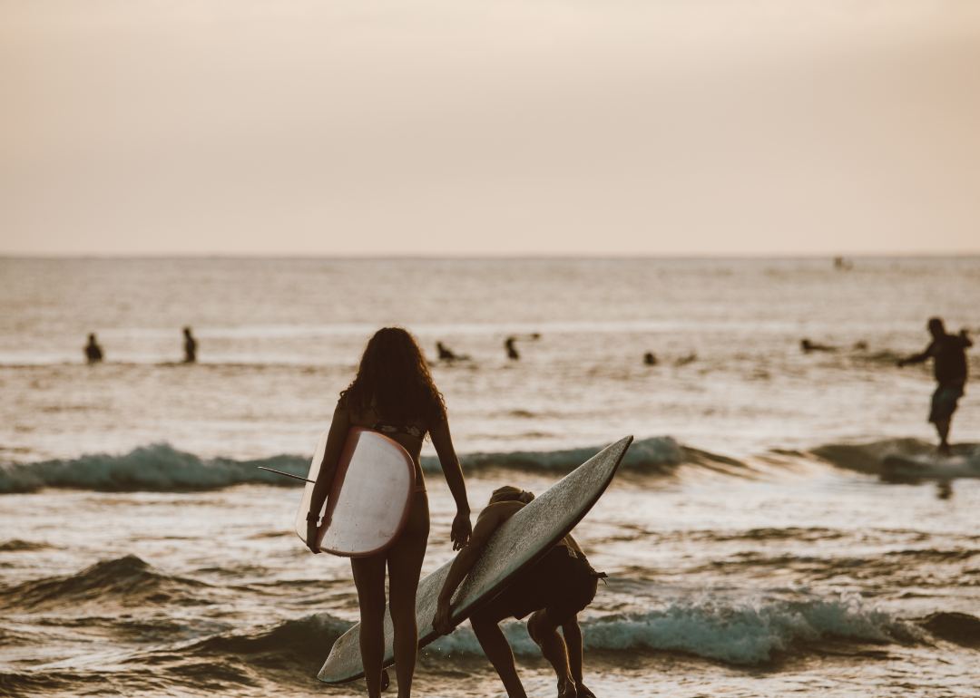 Surfers heading to the ocean.