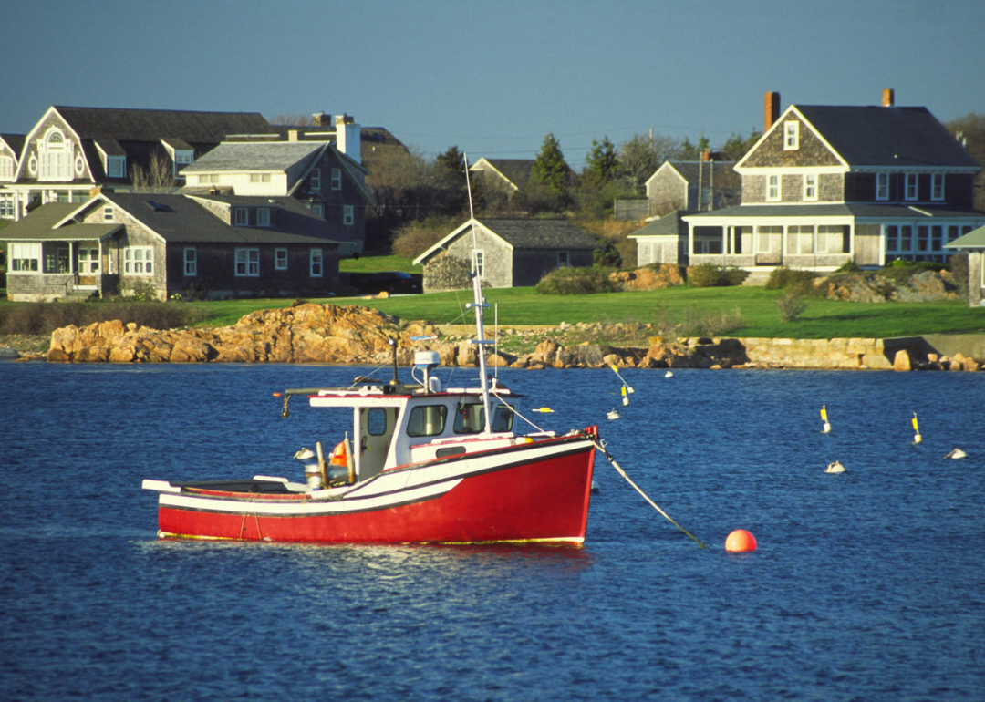 Homes and a red boat on the water.