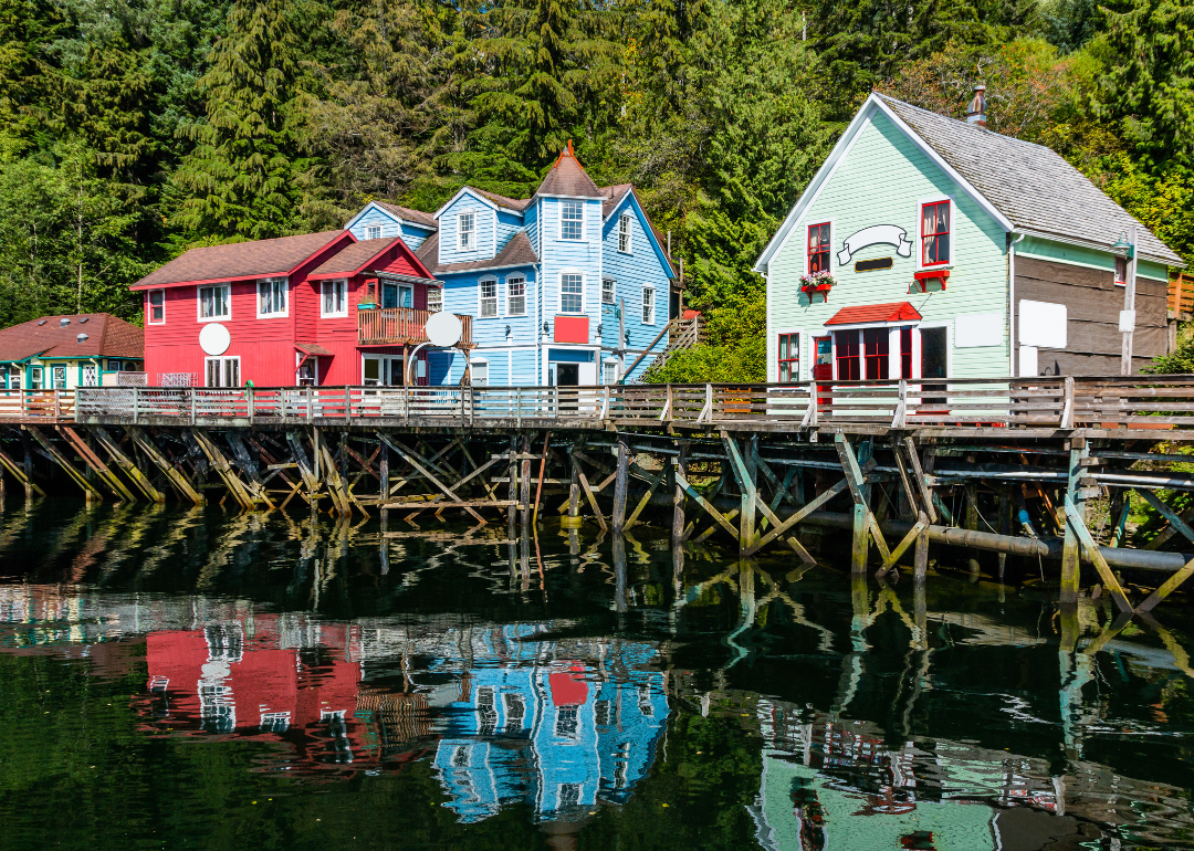 Colorful homes and a long pier on the water.